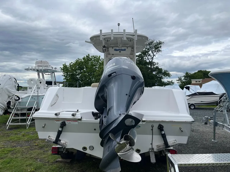 Slide: The Image of 2017 Sportsman Open 232 Center Console boat with outboard motor, parked outdoors. - 5