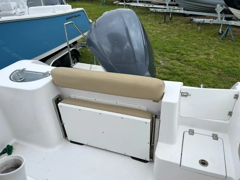 Slide: The Image of 2017 Sportsman Open 232 Center Console boat interior with seating and motor. - 8