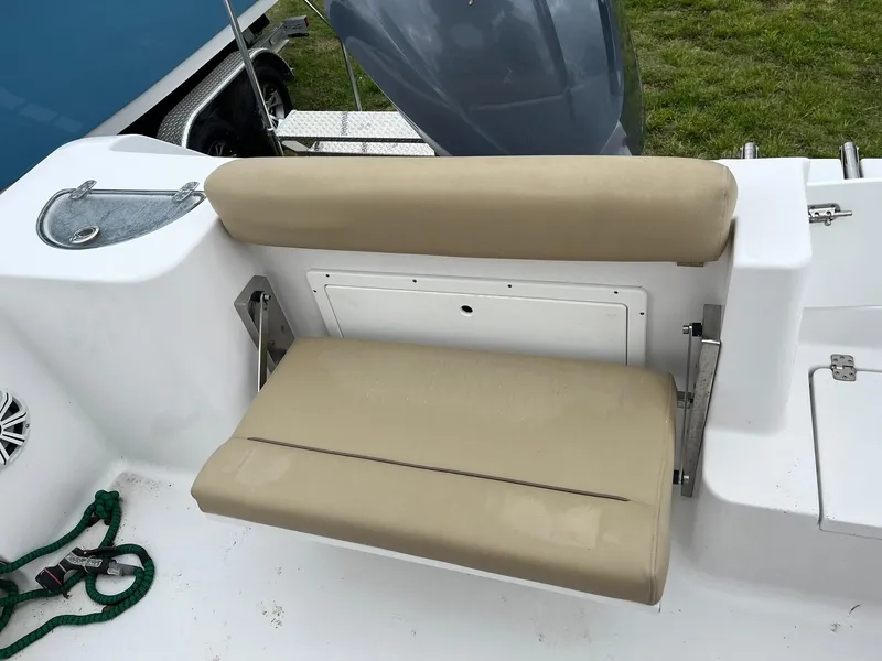 Slide: The Image of 2017 Sportsman Open 232 Center Console boat with beige cushioned seating. - 9