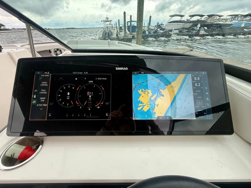 Slide: The Image of Dashboard of 2022 Sea Ray SLX 280 with navigation and control displays. - 15
