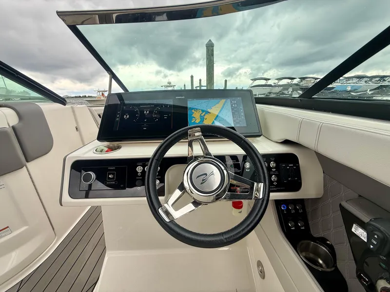 Slide: The Image of 2022 Sea Ray SLX 280 boat dashboard with steering wheel and navigation display. - 16