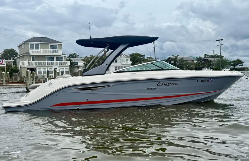 Slide: The Image of 2022 Sea Ray SLX 280 boat on water, featuring sleek design and canopy. - 2