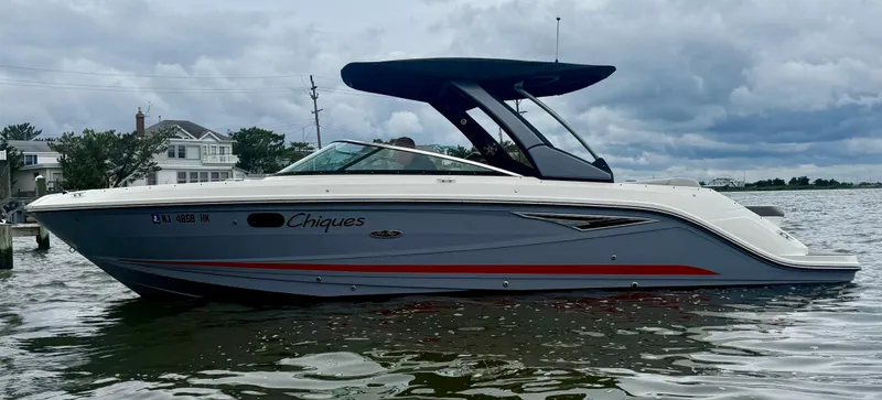 Slide: The Image of 2022 Sea Ray SLX 280 boat on water, overcast sky, side view. - 3