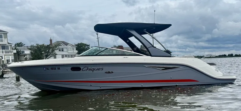 Slide: The Image of 2022 Sea Ray SLX 280 boat on water, overcast sky, side view. - 4