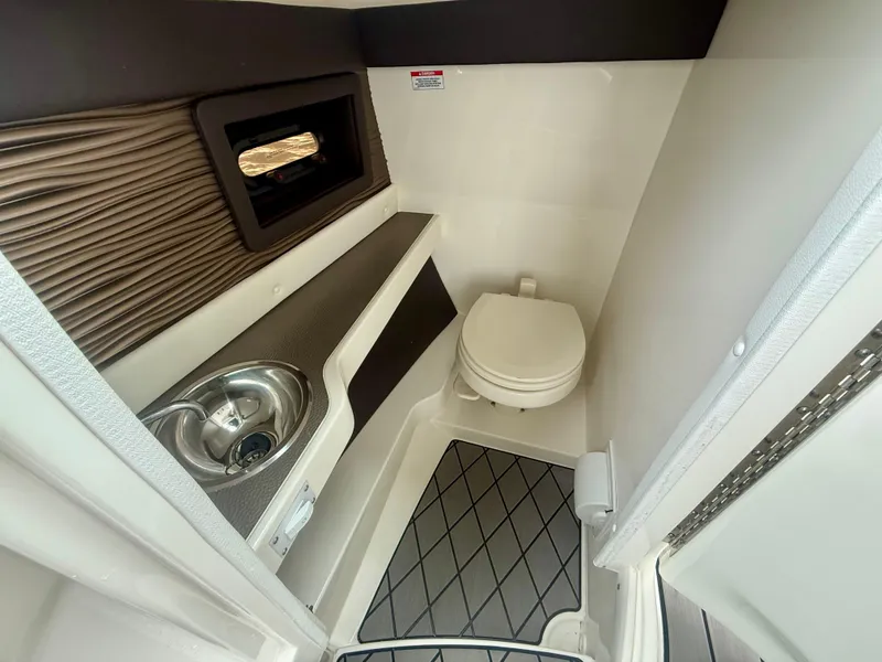 Slide: The Image of 2022 Sea Ray SLX 280 boat bathroom with sink and toilet. - 7