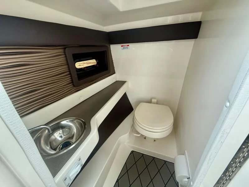 Slide: The Image of 2022 Sea Ray SLX 280 boat interior bathroom with sink and toilet. - 8