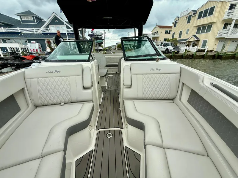 Slide: The Image of 2022 Sea Ray SLX 280 boat interior with luxurious seating and waterfront view. - 9