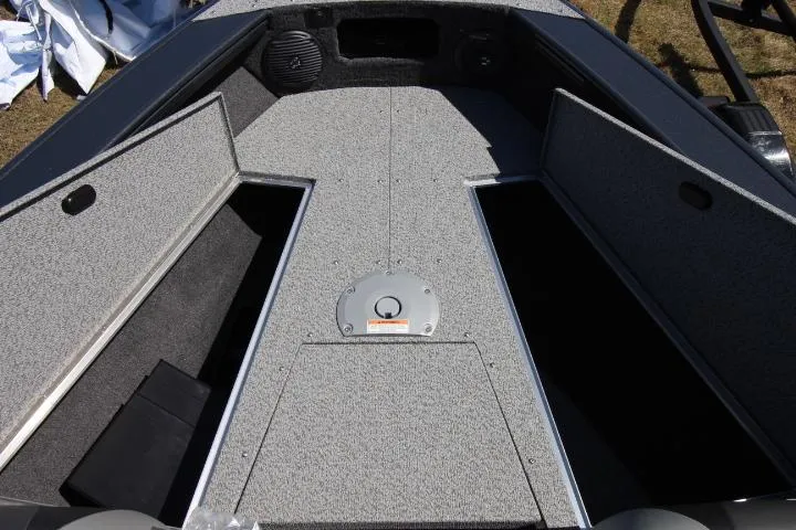 Slide: The Image of 2025 Lund 1775 Crossover XS boat interior with open storage compartments. - 10