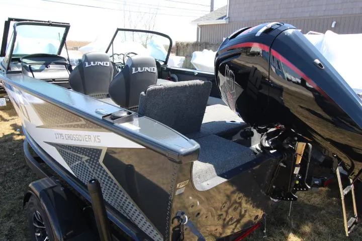 Slide: The Image of 2025 Lund 1775 Crossover XS boat with sleek design and powerful outboard motor. - 3