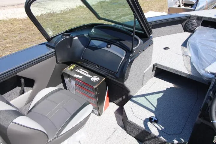 Slide: The Image of 2025 Lund 1775 Crossover XS boat interior with seating and storage box. - 7