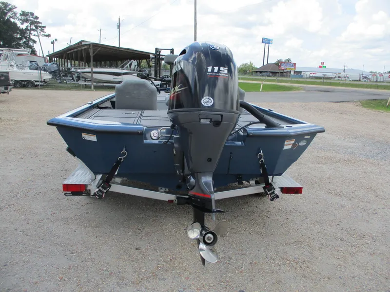 Slide: The Image of 2024 Avid 18XB boat with Yamaha 115 outboard motor, parked on a trailer. - 1