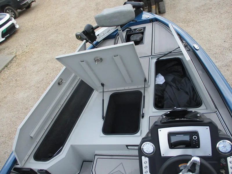 Slide: The Image of 2024 Avid 18XB boat interior with open storage compartments and control panel. - 4