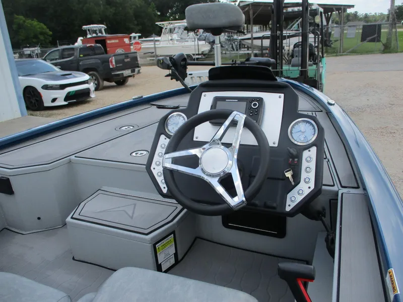 Slide: The Image of 2024 Avid 18XB boat interior with steering wheel and dashboard controls. - 5