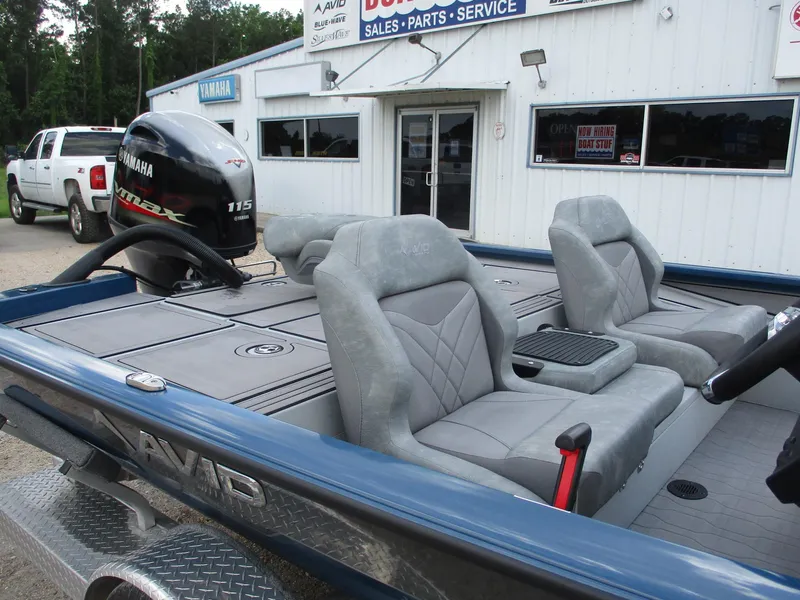 Slide: The Image of 2024 Avid 18XB boat with Yamaha 115 engine, parked outside dealership. - 6