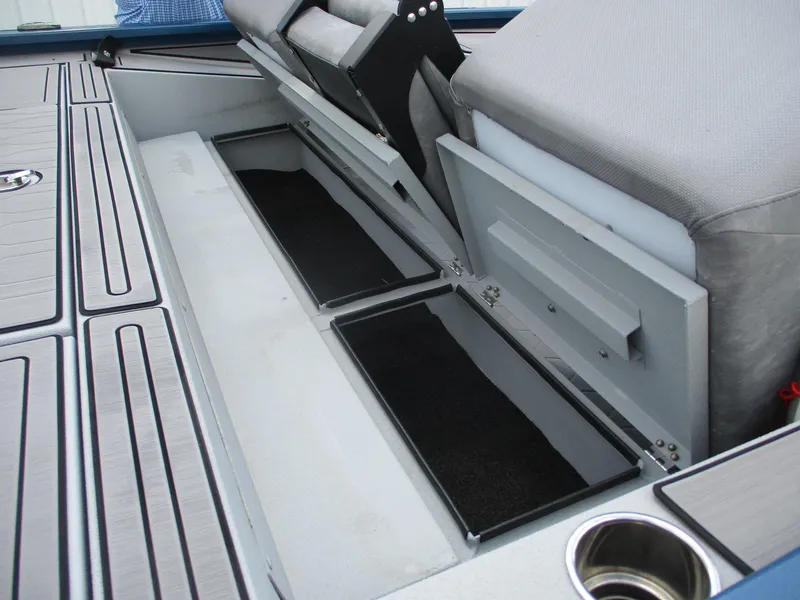 Slide: The Image of 2024 Avid 18XB boat interior with open storage compartments and seating. - 7