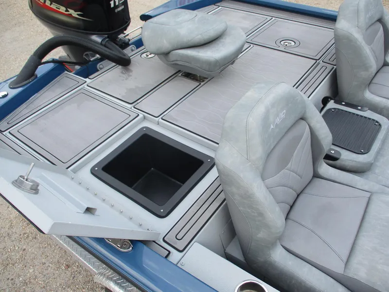 Slide: The Image of 2024 Avid 18XB boat interior with gray seating and storage compartments. - 8