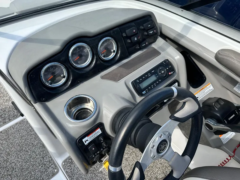 Slide: The Image of 2011 Yamaha 242 Limited Jet Boat dashboard with gauges, steering wheel, and controls. - 2