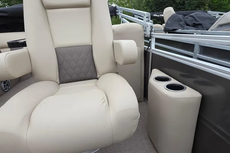 Slide: The Image of Luxurious seating on 2025 Sun Tracker PB 22 DLX pontoon boat with cup holders. - 13