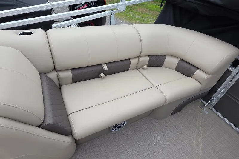Slide: The Image of 2025 Sun Tracker PB 22 DLX pontoon boat with beige and brown cushioned seating. - 2