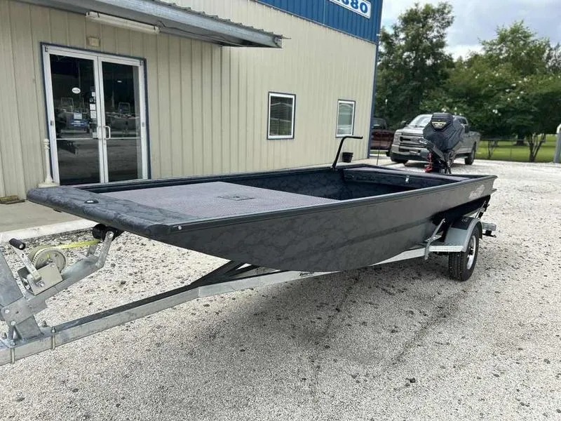 Slide: The Image of 2025 Gator Tail 1754 Extreme Series boat on trailer outside a building. - 2