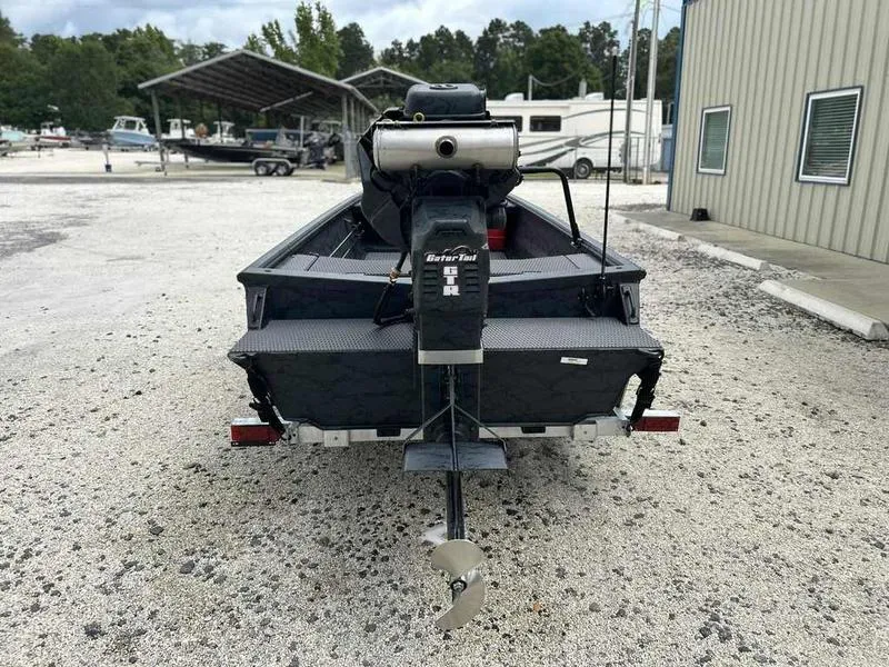 Slide: The Image of 2025 Gator Tail 1754 Extreme Series boat at a marina, rear view. - 5