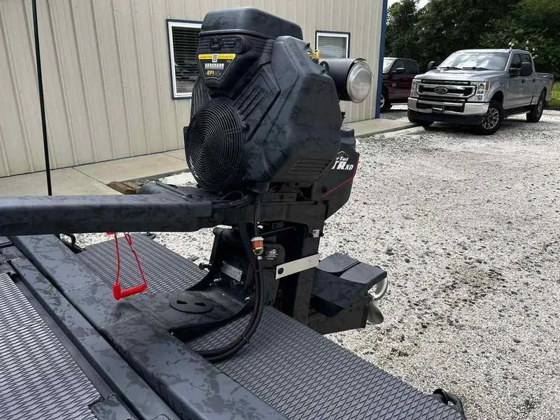 Slide: The Image of 2025 Gator Tail 1754 Extreme Series boat motor in a gravel lot, with a truck in the background. - 8