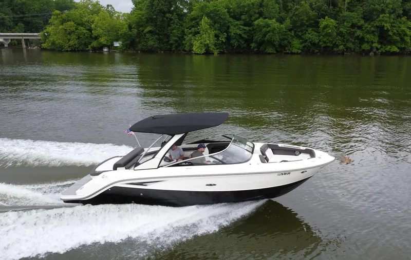 Slide: The Image of 2017 Sea Ray SLX 280 cruising on a calm river with lush green trees. - 1