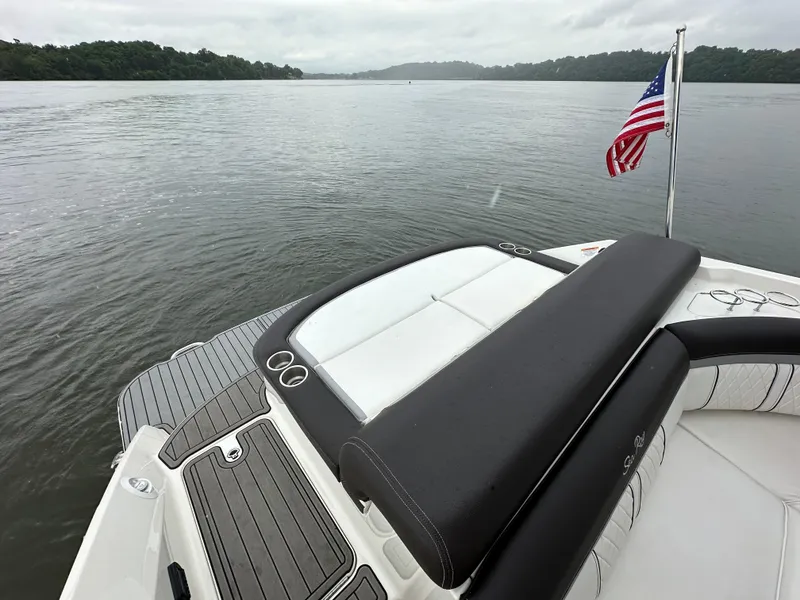 Slide: The Image of 2017 Sea Ray SLX 280 boat with American flag on calm lake. - 18