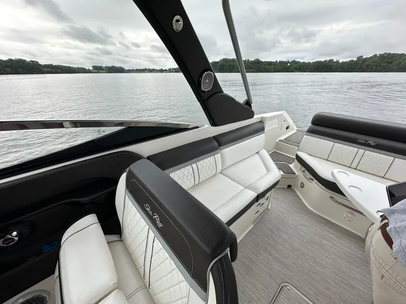 Slide: The Image of 2017 Sea Ray SLX 280 boat interior with luxurious seating on a calm lake. - 19