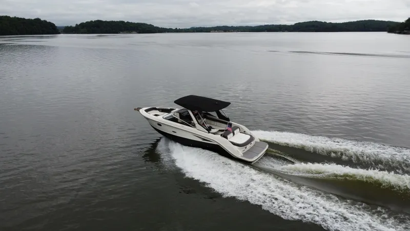 Slide: The Image of 2017 Sea Ray SLX 280 cruising on a calm lake, creating gentle waves. - 4