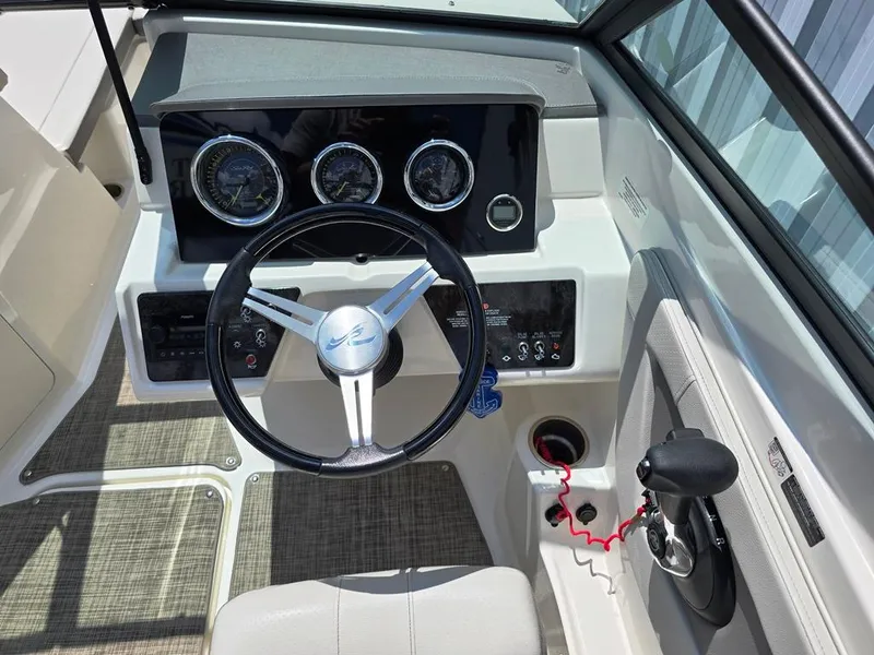 Slide: The Image of 2020 Sea Ray SPX 210 boat dashboard with steering wheel and control panel. - 16