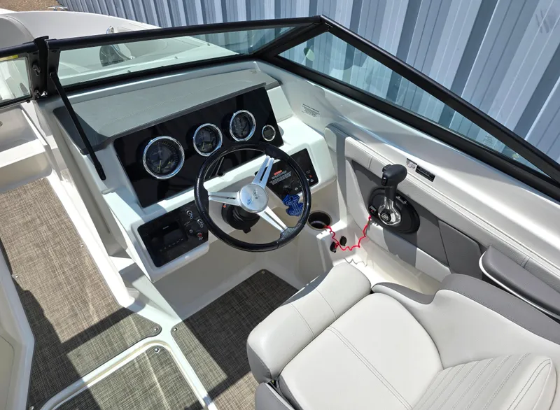 Slide: The Image of 2020 Sea Ray SPX 210 boat cockpit with steering wheel and control panel. - 3