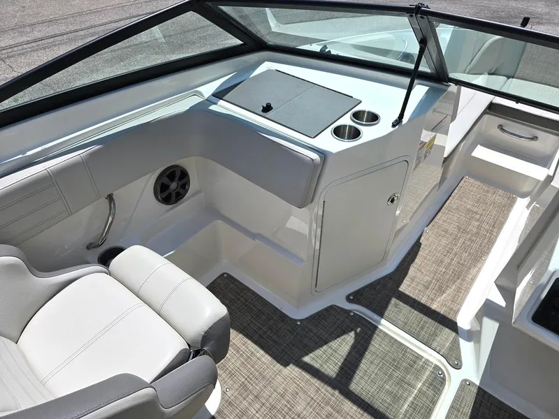 Slide: The Image of 2020 Sea Ray SPX 210 boat interior with seating and console, featuring cup holders and speaker. - 4