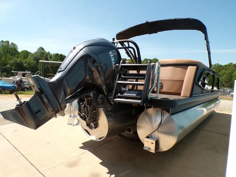 Slide: The Image of 2025 Godfrey AquaPatio 235 SBC pontoon boat with Yamaha outboard motor, docked outdoors. - 12