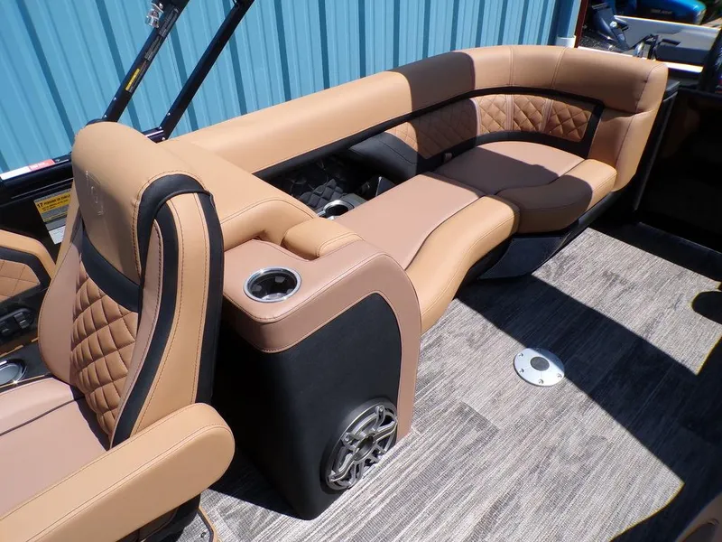 Slide: The Image of Luxurious seating on 2025 Godfrey AquaPatio 235 SBC iMPACT pontoon boat with tan upholstery. - 2
