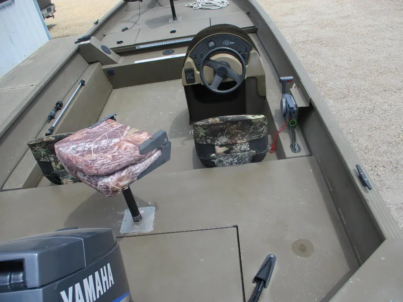 Slide: The Image of Interior of a 2010 G3 1966 SC boat with Yamaha motor and camouflage seats. - 11