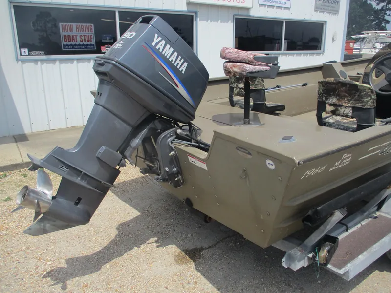 Slide: The Image of Boat with Yamaha outboard motor, G3 1966 SC model, parked outside a building. - 4