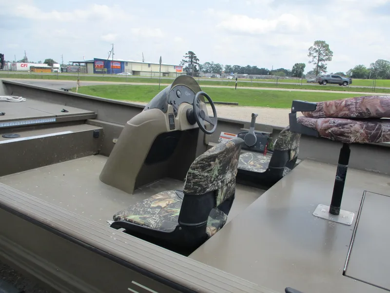 Slide: The Image of Interior of a 2010 G3 1966 SC boat with camouflage seats and steering console. - 8