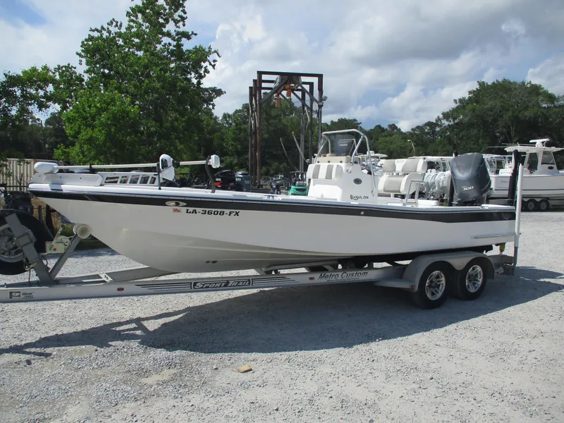 Slide: The Image of 2010 BlackJack 224 boat on trailer, parked outdoors under cloudy sky. - 1