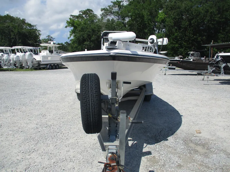 Slide: The Image of Front view of a 2010 BlackJack 224 boat on a trailer in a gravel lot. - 2