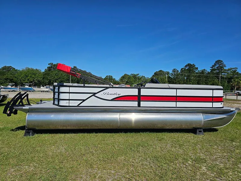 The Image of 2025 Bentley Pontoons Legacy 243 Cruise Tritoon on grass under clear blue sky. - 0