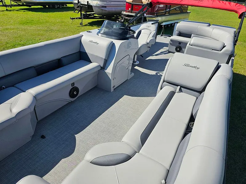Slide: The Image of 2025 Bentley Pontoons Legacy 243 Cruise Tritoon on grass, featuring sleek design and red canopy. - 10