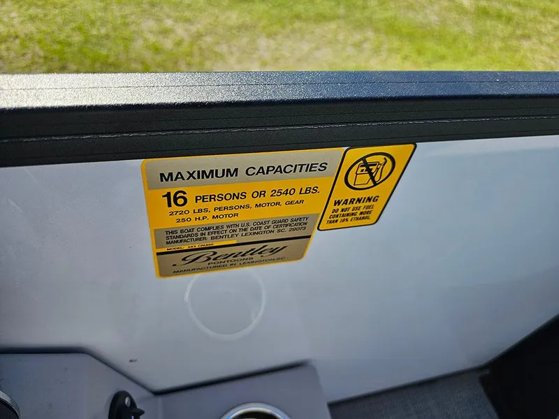 Slide: The Image of 2025 Bentley Pontoons Legacy 243 Cruise Tritoon helm with luxurious captain's chair and controls. - 17