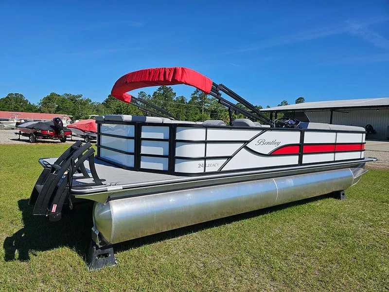 Slide: The Image of 2025 Bentley Pontoons Legacy 243 Cruise Tritoon on grass, red and white design. - 3