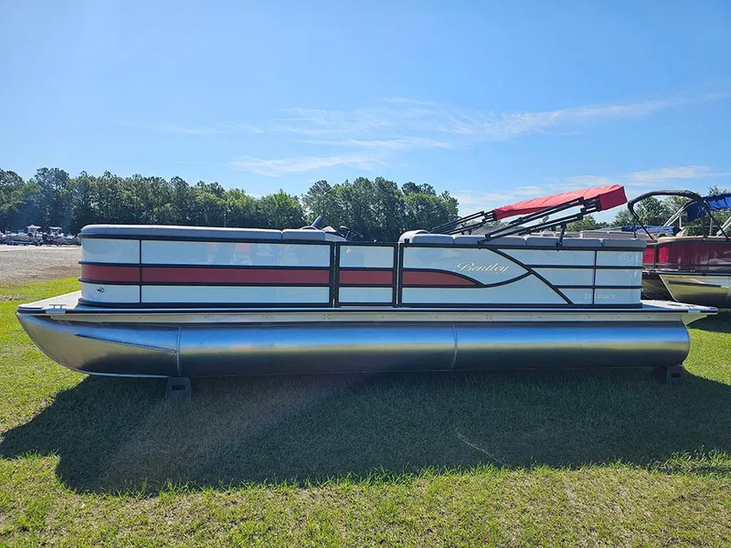 Slide: The Image of 2025 Bentley Pontoons Legacy 243 Cruise Tritoon on grass, showcasing sleek design and vibrant colors. - 6