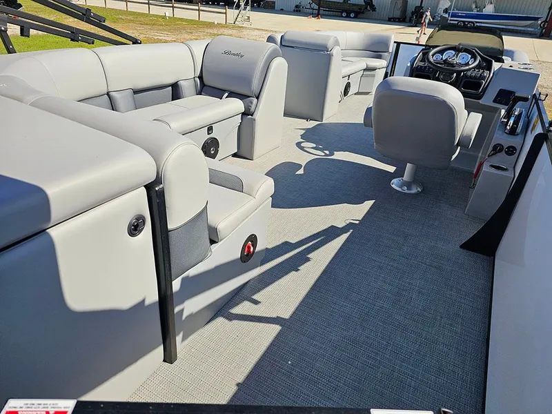 Slide: The Image of 2025 Bentley Pontoons Legacy 243 Cruise Tritoon on grass under clear blue sky. - 9