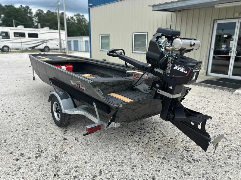 Slide: The Image of 2025 Gator Tail EXTREME MOD-V 1854 boat on trailer, parked outside a building. - 2