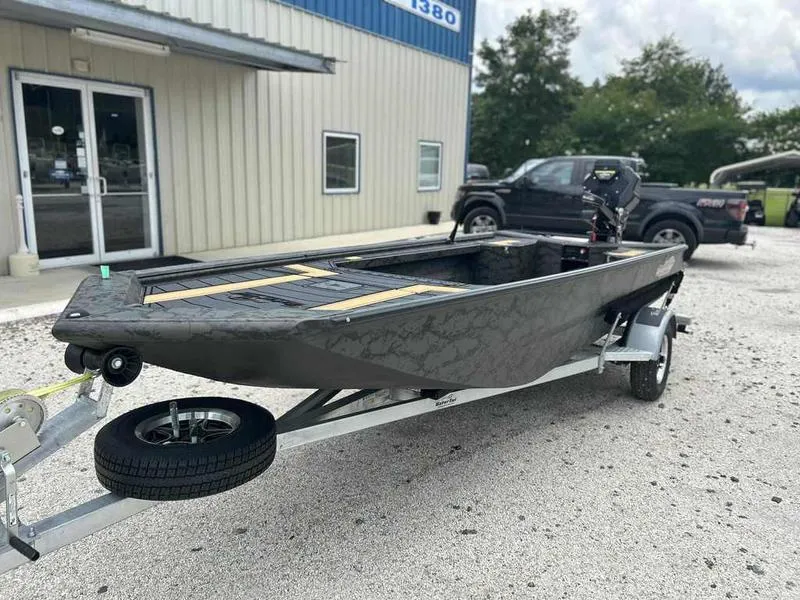 Slide: The Image of 2025 Gator Tail EXTREME MOD-V 1854 boat on trailer outside building. - 4