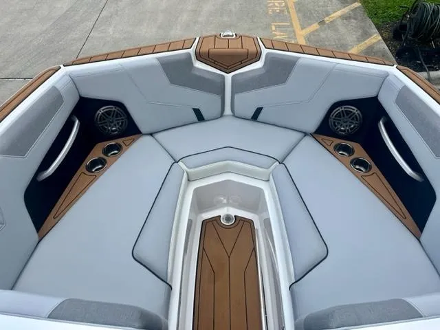 Slide: The Image of 2023 Nautique Super Air Nautique GS22 boat interior with sleek seating and cup holders. - 11