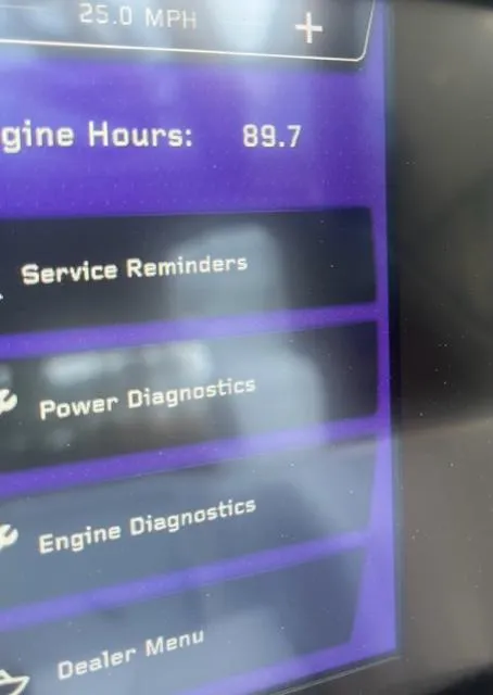 Slide: The Image of Close-up of 2023 Nautique Super Air Nautique GS22 dashboard showing engine hours and diagnostics menu. - 16